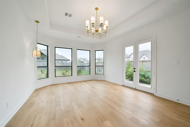 29602 Beech Tree Bnd, Fulshear, TX 77494 - unfurnished room with a chandelier, light wood finished floors, and a tray ceiling