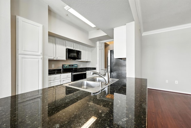 7575 Kirby Dr Unit 2204, Houston, TX 77030 - kitchen featuring appliances with stainless steel finishes, white cabinetry, ornamental molding, dark wood-style flooring, and dark stone counters