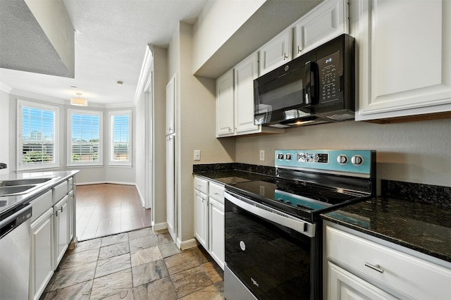 7575 Kirby Dr Unit 2204, Houston, TX 77030 - kitchen featuring stainless steel appliances, white cabinets, light stone finish floors, and dark stone countertops