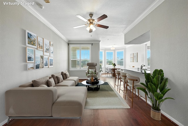 7575 Kirby Dr Unit 2204, Houston, TX 77030 - living room with wood finished floors, ceiling fan, ornamental molding, a textured ceiling, and a textured wall