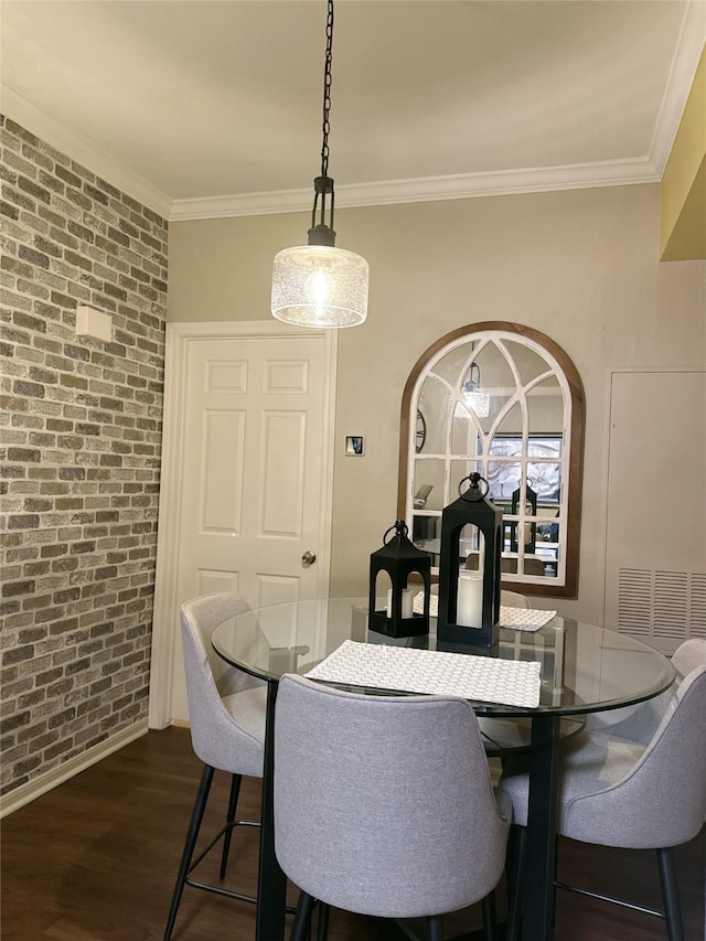 2255 Braeswood Park Dr Unit 145, Houston, TX 77030 - dining space featuring brick wall, dark wood finished floors, and crown molding