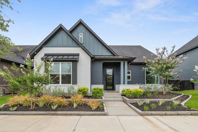 18615 Parkland Xing, Cypress, TX 77433 - view of front of property with board and batten siding, a shingled roof, and brick siding