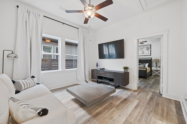 18615 Parkland Xing, Cypress, TX 77433 - living area with attic access, light wood-style flooring, and a ceiling fan