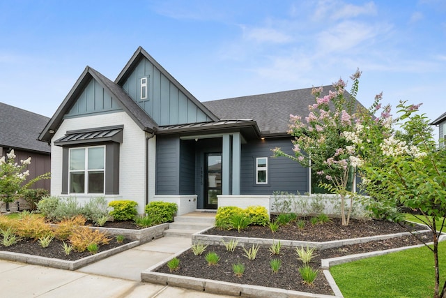 18615 Parkland Xing, Cypress, TX 77433 - view of front of property with brick siding, board and batten siding, a shingled roof, and a standing seam roof
