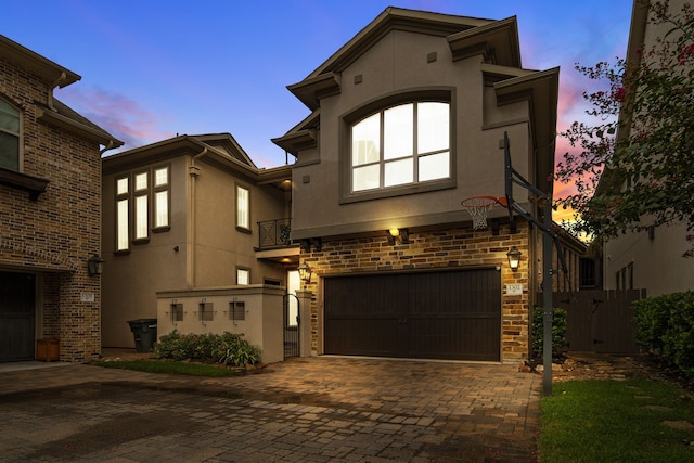 1302 Westview Garden Ct, Houston, TX 77055 - view of front of home featuring stucco siding, a garage, decorative driveway, and a gate