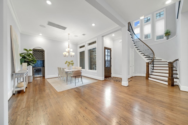 1302 Westview Garden Ct, Houston, TX 77055 - foyer featuring ornamental molding, stairs, a chandelier, wood finished floors, and recessed lighting