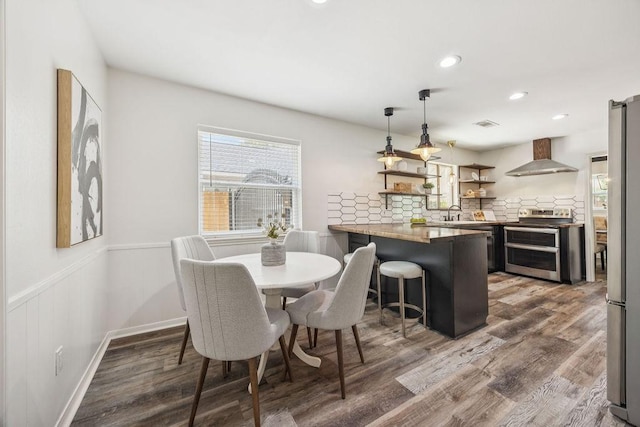 5515 Dumfries Dr, Houston, TX 77096 - dining room with wood finished floors, recessed lighting, and wainscoting
