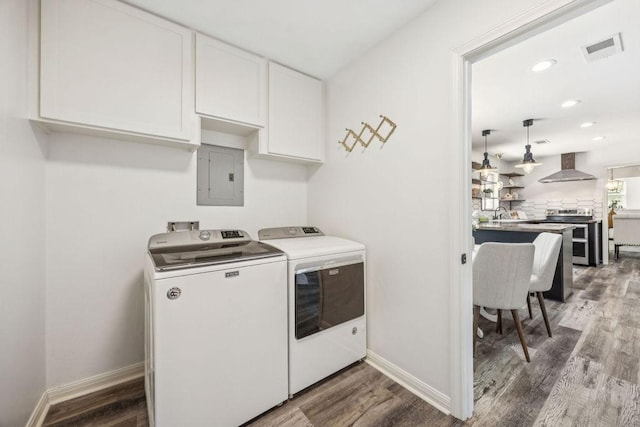 5515 Dumfries Dr, Houston, TX 77096 - laundry room featuring electric panel, cabinet space, washer and dryer, wood finished floors, and recessed lighting