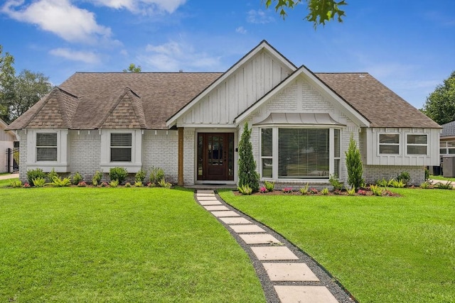 5515 Dumfries Dr, Houston, TX 77096 - view of front of property with a shingled roof, board and batten siding, a front yard, and brick siding