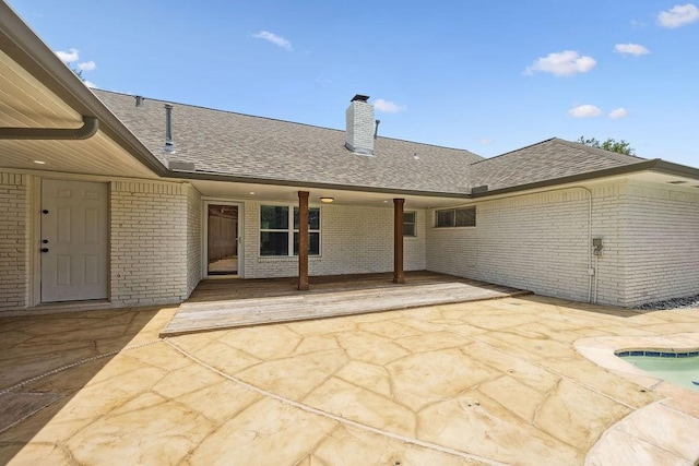 5515 Dumfries Dr, Houston, TX 77096 - back of house with brick siding, a patio area, and roof with shingles