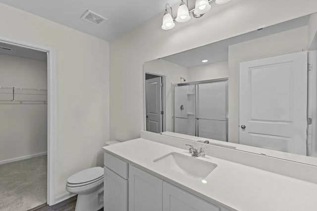 452 Harlow Dr, Montgomery, TX 77316 - full bath featuring a shower stall, a spacious closet, vanity, and wood finished floors