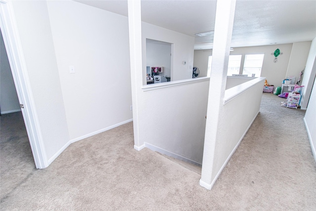 8222 Pastel Dawn Trce, Houston, TX 77049 - hall with carpet flooring and an upstairs landing