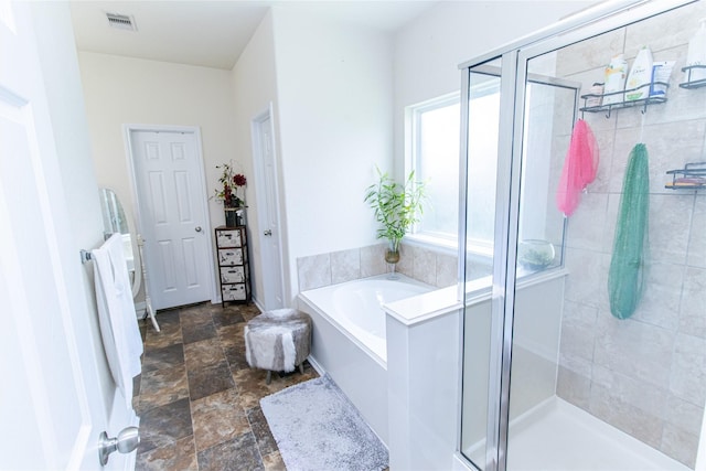 8222 Pastel Dawn Trce, Houston, TX 77049 - full bathroom with a bath, a shower stall, and stone finish floors
