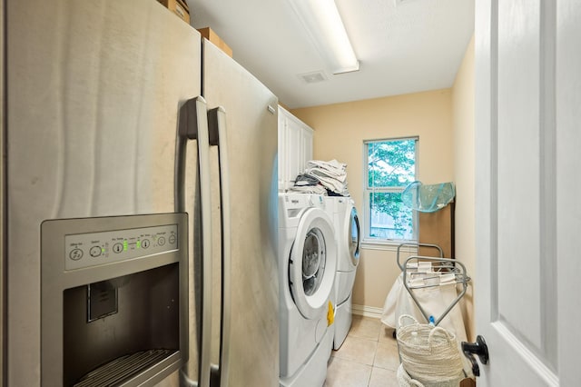 16018 Lower Lake Dr, Cypress, TX 77433 - washroom with cabinet space, light tile patterned floors, and washing machine and dryer
