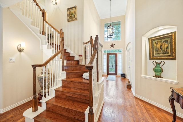 16018 Lower Lake Dr, Cypress, TX 77433 - entryway with plenty of natural light, a high ceiling, stairway, wood finished floors, and ornamental molding