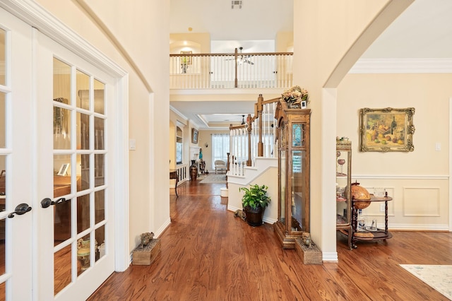 16018 Lower Lake Dr, Cypress, TX 77433 - foyer entrance featuring french doors, crown molding, arched walkways, wood finished floors, and stairs