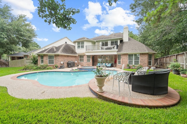 16018 Lower Lake Dr, Cypress, TX 77433 - back of house featuring a balcony, brick siding, a fenced backyard, an outdoor living space, and a chimney
