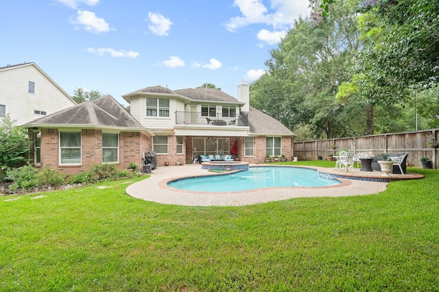 16018 Lower Lake Dr, Cypress, TX 77433 - rear view of property featuring a balcony, brick siding, a chimney, and a patio area