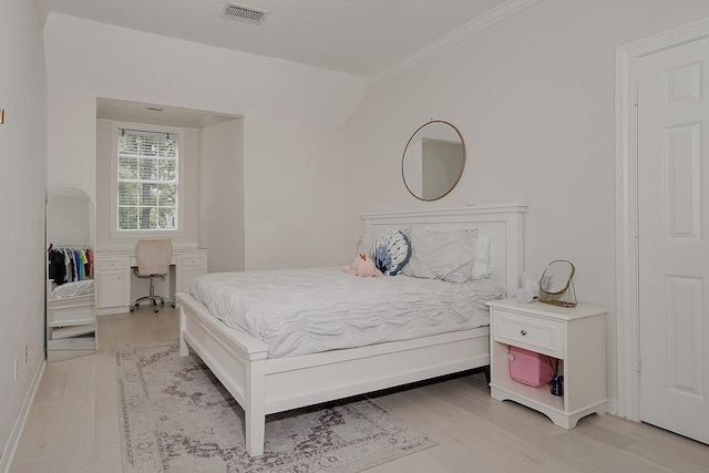 26 W Fairbranch Cir, The Woodlands, TX 77382 - bedroom featuring ornamental molding, light wood-type flooring, and lofted ceiling