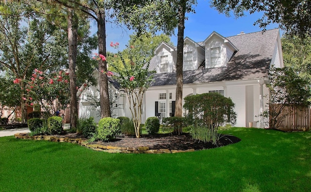 26 W Fairbranch Cir, The Woodlands, TX 77382 - new england style home featuring a front yard and roof with shingles