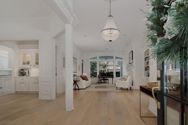 26 W Fairbranch Cir, The Woodlands, TX 77382 - corridor featuring light wood-style flooring, a chandelier, crown molding, and recessed lighting