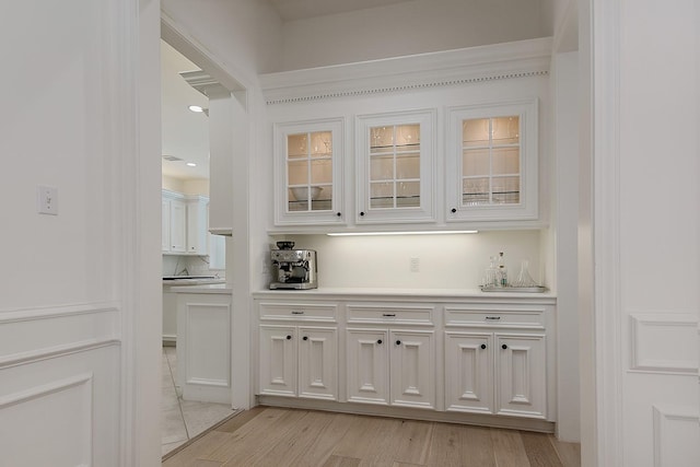 26 W Fairbranch Cir, The Woodlands, TX 77382 - indoor dry bar with light wood-style flooring