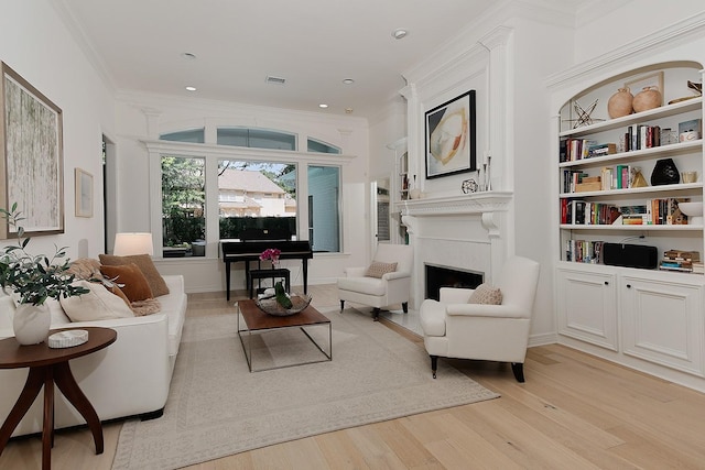 26 W Fairbranch Cir, The Woodlands, TX 77382 - living room with light wood-type flooring, a fireplace, ornamental molding, and recessed lighting