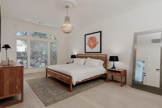 26 W Fairbranch Cir, The Woodlands, TX 77382 - bedroom with ornamental molding, a chandelier, and light wood-type flooring
