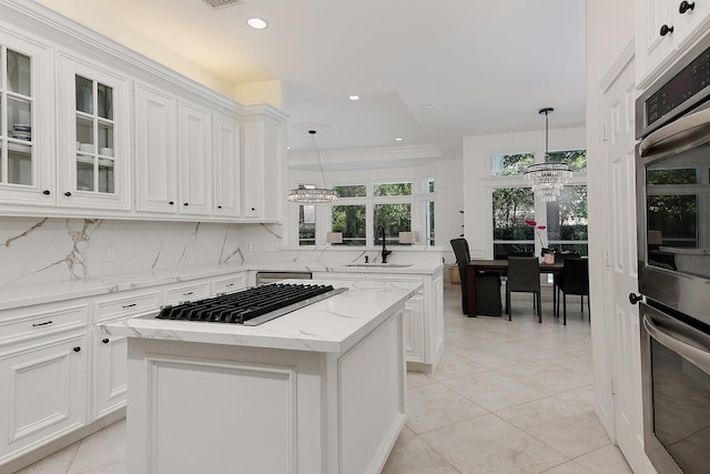 26 W Fairbranch Cir, The Woodlands, TX 77382 - kitchen with stainless steel appliances, recessed lighting, tasteful backsplash, white cabinets, and glass insert cabinets