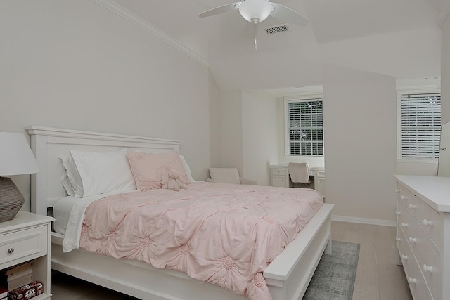 26 W Fairbranch Cir, The Woodlands, TX 77382 - bedroom with light wood-style flooring, a ceiling fan, and crown molding