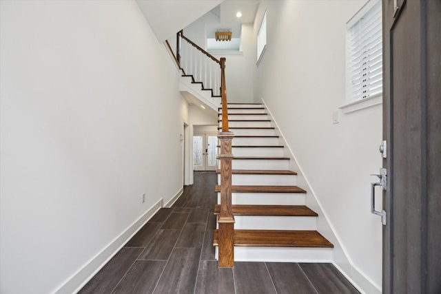 1408 Ruthven St, Houston, TX 77019 - stairway featuring wood tiled floors, a towering ceiling, and recessed lighting