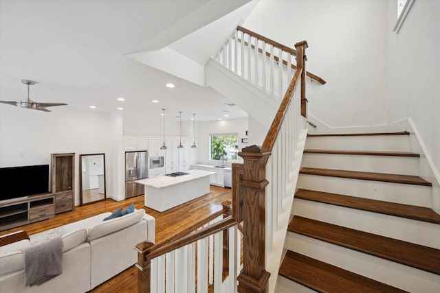 1408 Ruthven St, Houston, TX 77019 - stairs featuring wood finished floors, ceiling fan, and recessed lighting