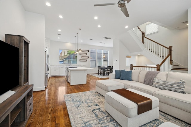 1408 Ruthven St, Houston, TX 77019 - living room with ceiling fan, dark wood-style flooring, recessed lighting, and stairway