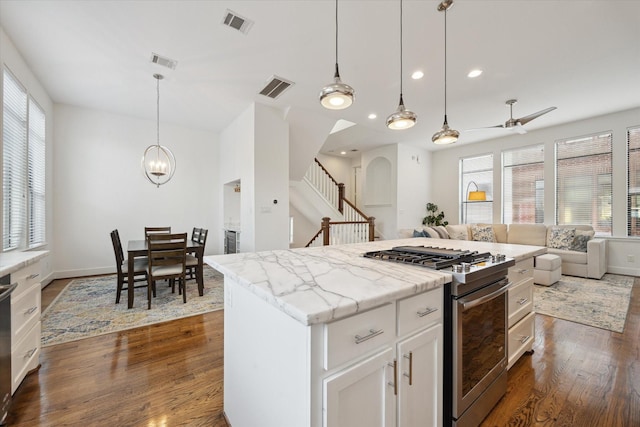 1408 Ruthven St, Houston, TX 77019 - kitchen featuring stainless steel appliances, open floor plan, dark wood-style floors, white cabinetry, and recessed lighting
