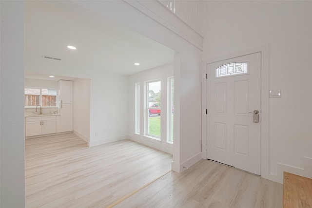 17802 Poppy Trails Ln, Houston, TX 77084 - entryway with light wood-style floors, healthy amount of natural light, and recessed lighting
