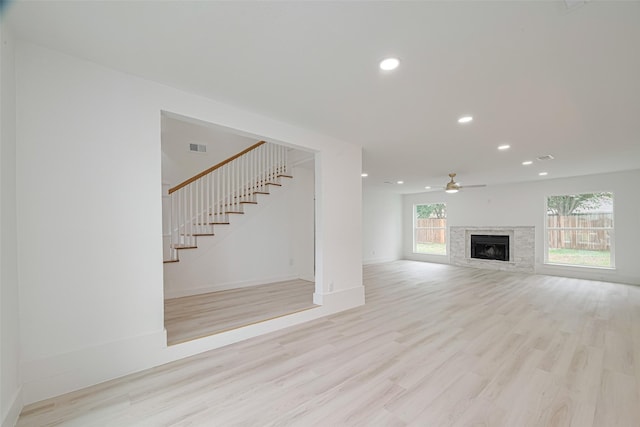 17802 Poppy Trails Ln, Houston, TX 77084 - unfurnished living room with stairs, a fireplace, wood finished floors, ceiling fan, and recessed lighting