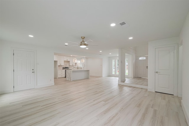 17802 Poppy Trails Ln, Houston, TX 77084 - unfurnished living room featuring a ceiling fan, light wood-type flooring, and recessed lighting