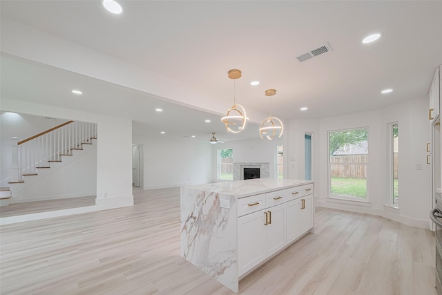 17802 Poppy Trails Ln, Houston, TX 77084 - kitchen featuring open floor plan, light wood finished floors, plenty of natural light, light stone countertops, and recessed lighting