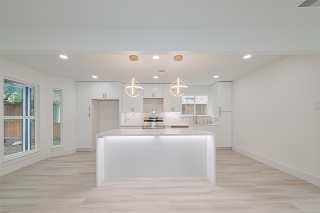 17802 Poppy Trails Ln, Houston, TX 77084 - kitchen featuring electric stove, white cabinetry, healthy amount of natural light, and recessed lighting