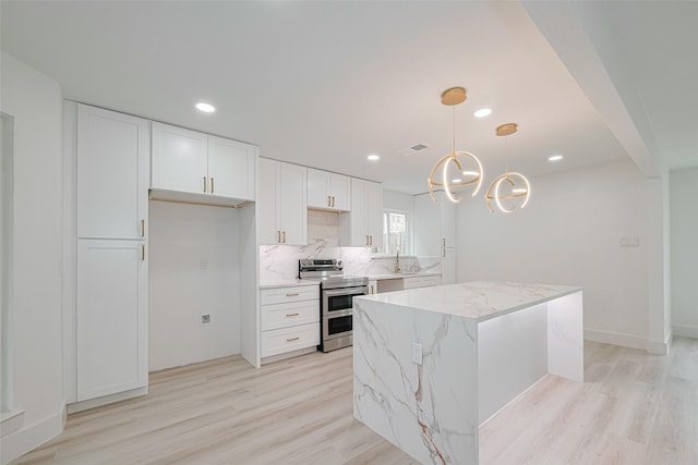 17802 Poppy Trails Ln, Houston, TX 77084 - kitchen featuring range with two ovens, light wood finished floors, white cabinetry, a kitchen island, and recessed lighting
