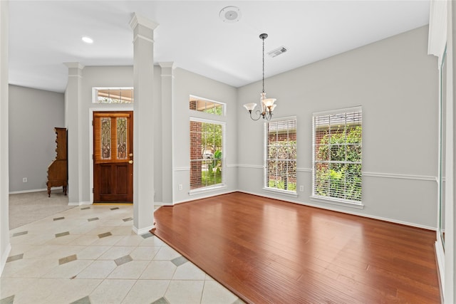 3406 Mcmahon Way, Missouri City, TX 77459 - empty room featuring ornate columns, light tile patterned flooring, a chandelier, and recessed lighting