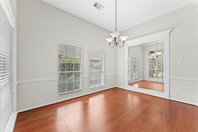 3406 Mcmahon Way, Missouri City, TX 77459 - unfurnished dining area with a chandelier, wood finished floors, and healthy amount of natural light