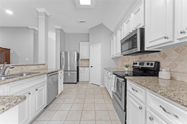 3406 Mcmahon Way, Missouri City, TX 77459 - kitchen featuring stainless steel appliances, decorative backsplash, white cabinetry, light tile patterned flooring, and light stone countertops