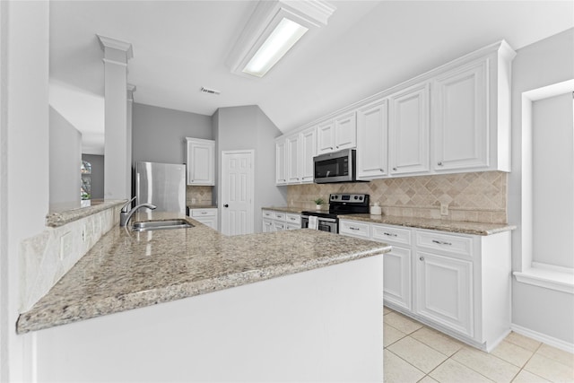 3406 Mcmahon Way, Missouri City, TX 77459 - kitchen featuring appliances with stainless steel finishes, backsplash, white cabinetry, light stone counters, and lofted ceiling