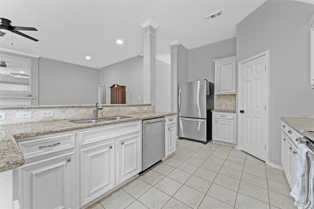 3406 Mcmahon Way, Missouri City, TX 77459 - kitchen with stainless steel appliances, tasteful backsplash, light tile patterned floors, ceiling fan, and white cabinets