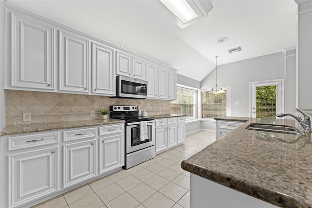 3406 Mcmahon Way, Missouri City, TX 77459 - kitchen featuring stainless steel appliances, light tile patterned flooring, lofted ceiling, decorative backsplash, and white cabinetry