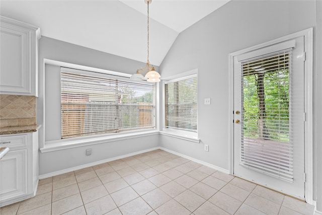3406 Mcmahon Way, Missouri City, TX 77459 - unfurnished dining area with vaulted ceiling, light tile patterned floors, and a chandelier