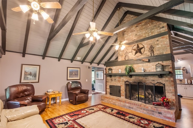 24917 W Christine Dr, Splendora, TX 77372 - living area with ceiling fan, light wood-type flooring, a brick fireplace, healthy amount of natural light, and high vaulted ceiling