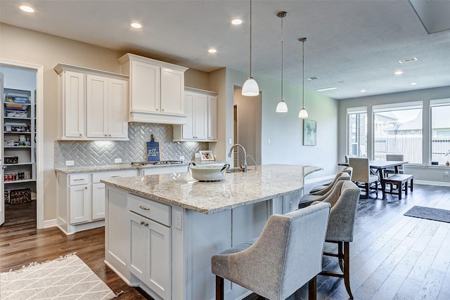 28606 Royal Pines Ct, Fulshear, TX 77441 - kitchen with white cabinetry, dark wood-type flooring, decorative backsplash, and recessed lighting