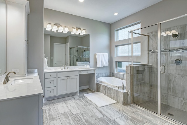 28606 Royal Pines Ct, Fulshear, TX 77441 - bathroom with two vanities, a stall shower, a garden tub, and recessed lighting